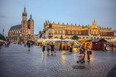 a group of people walking on a street in front of a building at Your stylish spot in the center of Kraków in Kraków