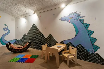 a room with a mural of a dragon on the wall at Krakowiaki in Kraków