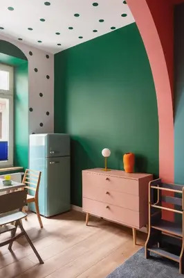 a childs room with a green wall with an arch at Krakowiaki in Kraków