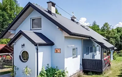 a blue house with a black roof at Pet Friendly Apartment In Spytkowice in Spytkowice