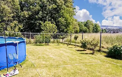 a tennis court with two tennis rackets in a yard at Pet Friendly Apartment In Spytkowice in Spytkowice