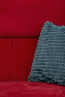 a blue blanket sitting on top of a red couch at Kraków Elegant Apartment Near The Water Park by Rent like home in Kraków