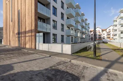 an empty street in front of a building at Kraków Elegant Apartment Near The Water Park by Rent like home in Kraków
