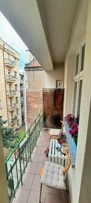 a balcony with chairs and a large screen on a building at Old Town Apartment Kazimierz in Kraków