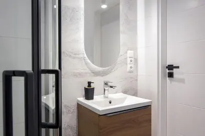 a bathroom with a sink and a mirror at Old Town Apartment Kazimierz in Kraków