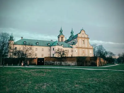 a large white building with a green roof at Old Town Apartment Kazimierz in Kraków