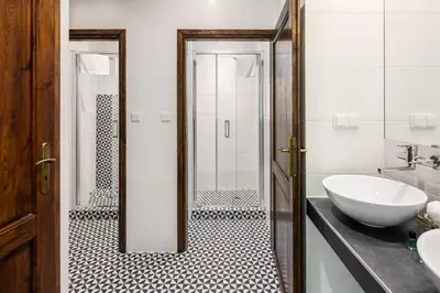 a bathroom with a white sink and a shower at Garden House Apartments in Kraków