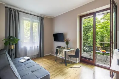 a living room with a couch and a table at Garden House Apartments in Kraków