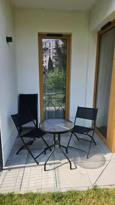 a table and two chairs sitting on a patio at Apartament Orawska in Kraków