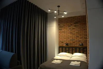 a bedroom with a bed with two towels on it at Apartament Orawska in Kraków