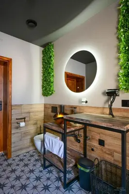 a bathroom with a sink and a mirror at Aparthotel Mamma Mia - Oświęcim in Oświęcim