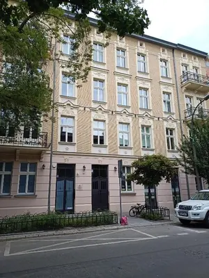 a large brick building on the side of a street at Apartments in the heart of the city in Kraków