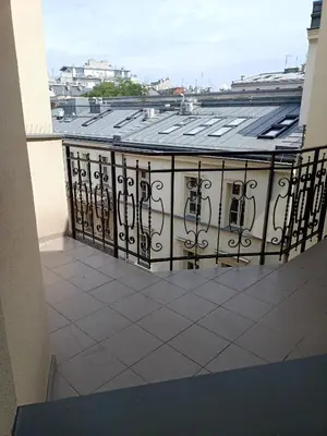 a balcony with an iron fence on a building at Apartments in the heart of the city in Kraków
