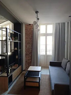 a living room with a couch and a coffee table at Apartments in the heart of the city in Kraków