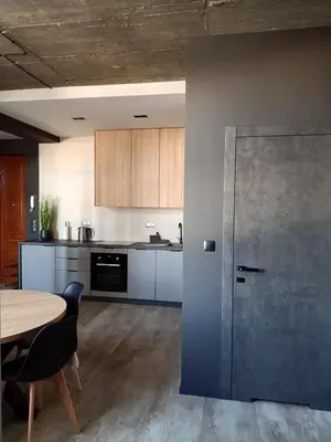 a kitchen with a table and a door in a room at Apartments in the heart of the city in Kraków