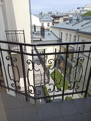 a balcony with a wrought iron railing with a view at Apartments in the heart of the city in Kraków