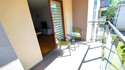 a balcony with a table and chairs on a building at Bianco Apartament Reduta Park Free Parking in Kraków