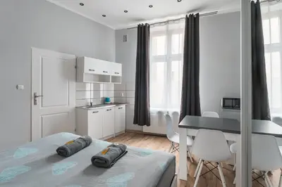 a bathroom with a shower and a toilet and a sink at 70s Business Room in Kraków
