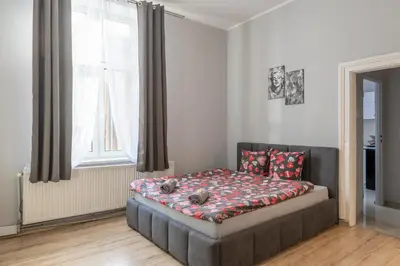 a room with a bed and a kitchen with a mirror at 70s Business Room in Kraków