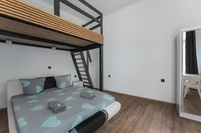 a bedroom with a bed and a table and chairs at 70s Business Room in Kraków