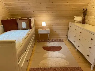 a bedroom with a bed and a dresser and a night stand at Panorama Sucha Góra in Skawica