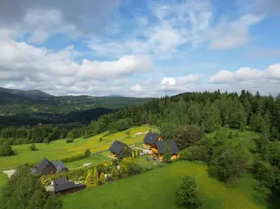 an aerial view of a house in a green field at Panorama Sucha Góra in Skawica