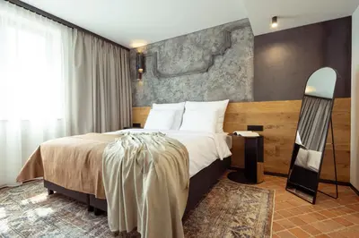 a bedroom with a large bed and a mirror at Nomadic Urban Premium Suites in Kraków