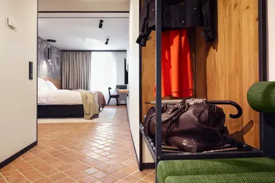 a room with a closet with a bag and a bedroom at Nomadic Urban Premium Suites in Kraków