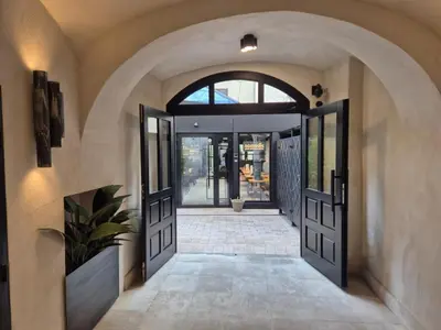 an entrance to a house with doors and a plant at Nomadic Urban Premium Suites in Kraków