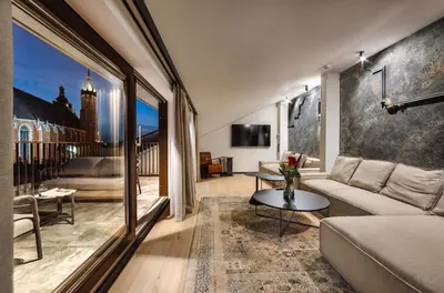 a living room with a couch and a table at Nomadic Urban Premium Suites in Kraków