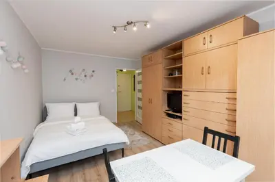 a bedroom with a bed and a table and chairs at Krowoderskich Zuchów Standard Studio by BookingHost in Kraków