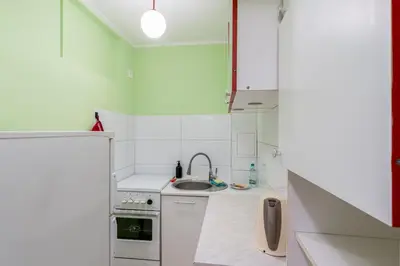 a small kitchen with a sink and a refrigerator at Krowoderskich Zuchów Standard Studio by BookingHost in Kraków