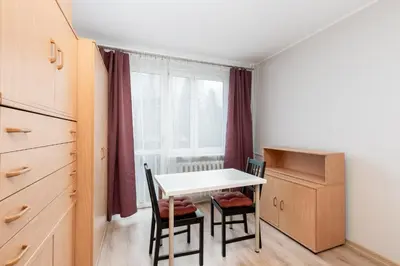 a kitchen with a table and chairs and a window at Krowoderskich Zuchów Standard Studio by BookingHost in Kraków