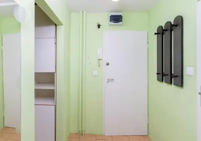 a hallway with a door and a closet at Krowoderskich Zuchów Standard Studio by BookingHost in Kraków