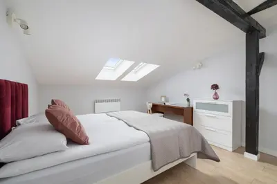 a white bedroom with a bed and a desk at Apartment with 2 Bedrooms and Desks in the Center of Cracow by Noclegi Renters in Kraków