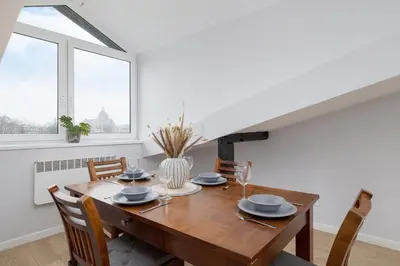 a dining room with a wooden table and chairs at Apartment with 2 Bedrooms and Desks in the Center of Cracow by Noclegi Renters in Kraków