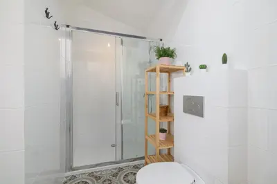a white bathroom with a shower and a toilet at Apartment with 2 Bedrooms and Desks in the Center of Cracow by Noclegi Renters in Kraków