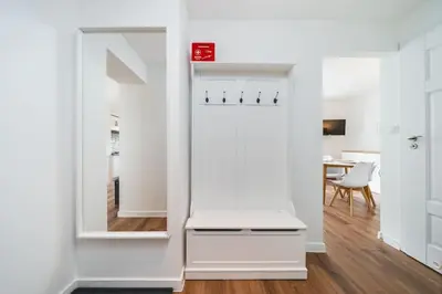 a white room with a mirror and a table at Close to everywhere, cosy place in Kraków