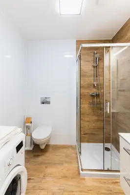 a bathroom with a shower with a toilet and a sink at Apartment Quiet Street 11/5E in Oświęcim
