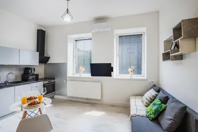 a living room with a couch and a table at Apartment Quiet Street 11/5E in Oświęcim