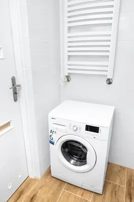 a washer and dryer in a white laundry room at Apartment Quiet Street 11/5E in Oświęcim