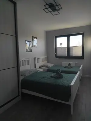 a bedroom with two beds and a window at Przewóz Lux Lucky Apartments Garaż w cenie in Kraków
