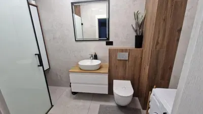 a bathroom with a sink and a toilet and a mirror at Przewóz Lux Lucky Apartments Garaż w cenie in Kraków