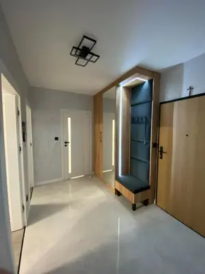 an empty hallway with a chair and a door at Przewóz Lux Lucky Apartments Garaż w cenie in Kraków