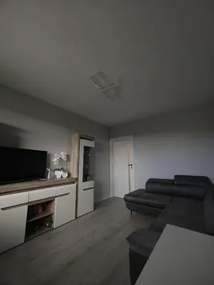 a living room with a couch and a flat screen tv at Przewóz Lux Lucky Apartments Garaż w cenie in Kraków