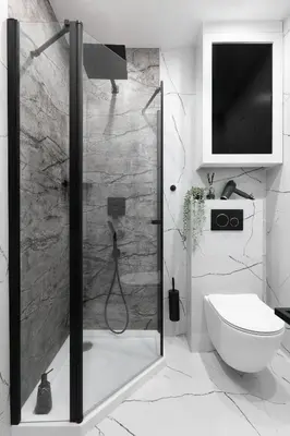 a bathroom with a shower with a toilet and a television at Cozy studio with Air Conditioning for couples, Old Town - Jewish District in Kraków