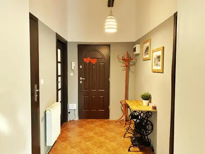 a hallway with a door and a table in a room at Luxury, spacious apartament with two bedrooms and balcony in Przybysławice