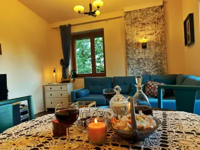 a living room with a table with wine glasses and a candle at Luxury, spacious apartament with two bedrooms and balcony in Przybysławice
