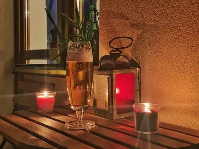 a glass of beer and candles on a table at Luxury, spacious apartament with two bedrooms and balcony in Przybysławice