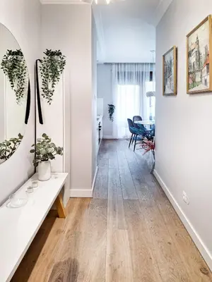 a hallway with white walls and a table with plants at Classy 2-room Apartment with Private Garden and Air Conditioning- Old Town in Kraków